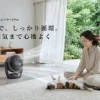 マットブラックのSwitchBotスマートサーキュレーター2 Proと女性、猫がいるリビングの様子