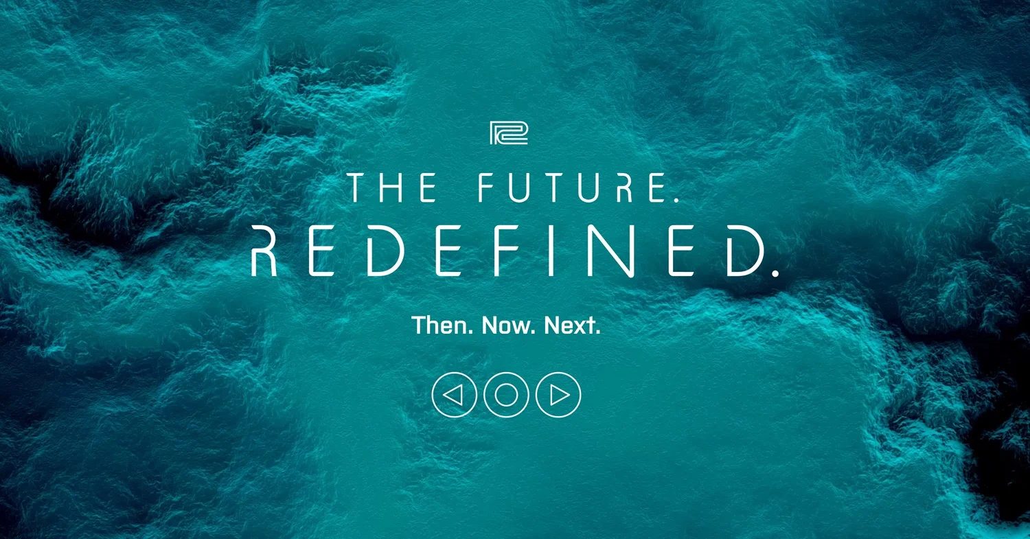 青いインクのような背景にTHE FUTURE. REDEFINED. Then. Now. Next