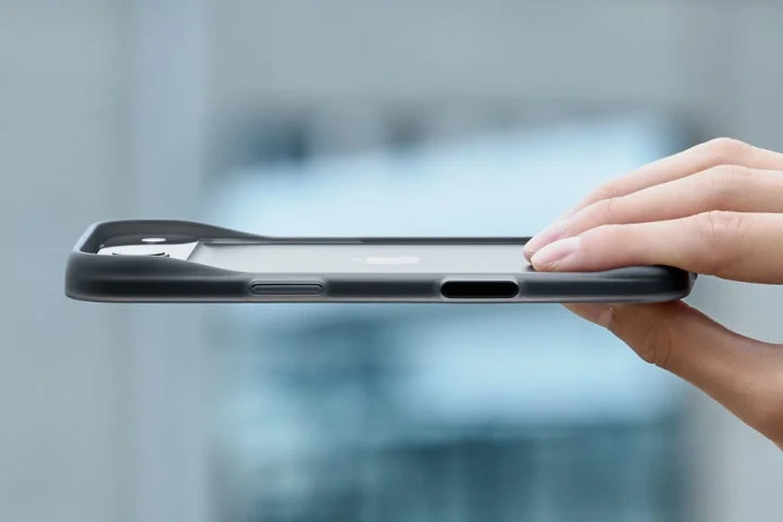 手に持たれたiPhoneの側面から、背面が空いた薄型バンパーケースの形状を示す