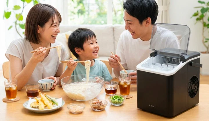 食卓で家族がALTENA高速製氷機を使って冷たい麺料理を楽しんでいる様子