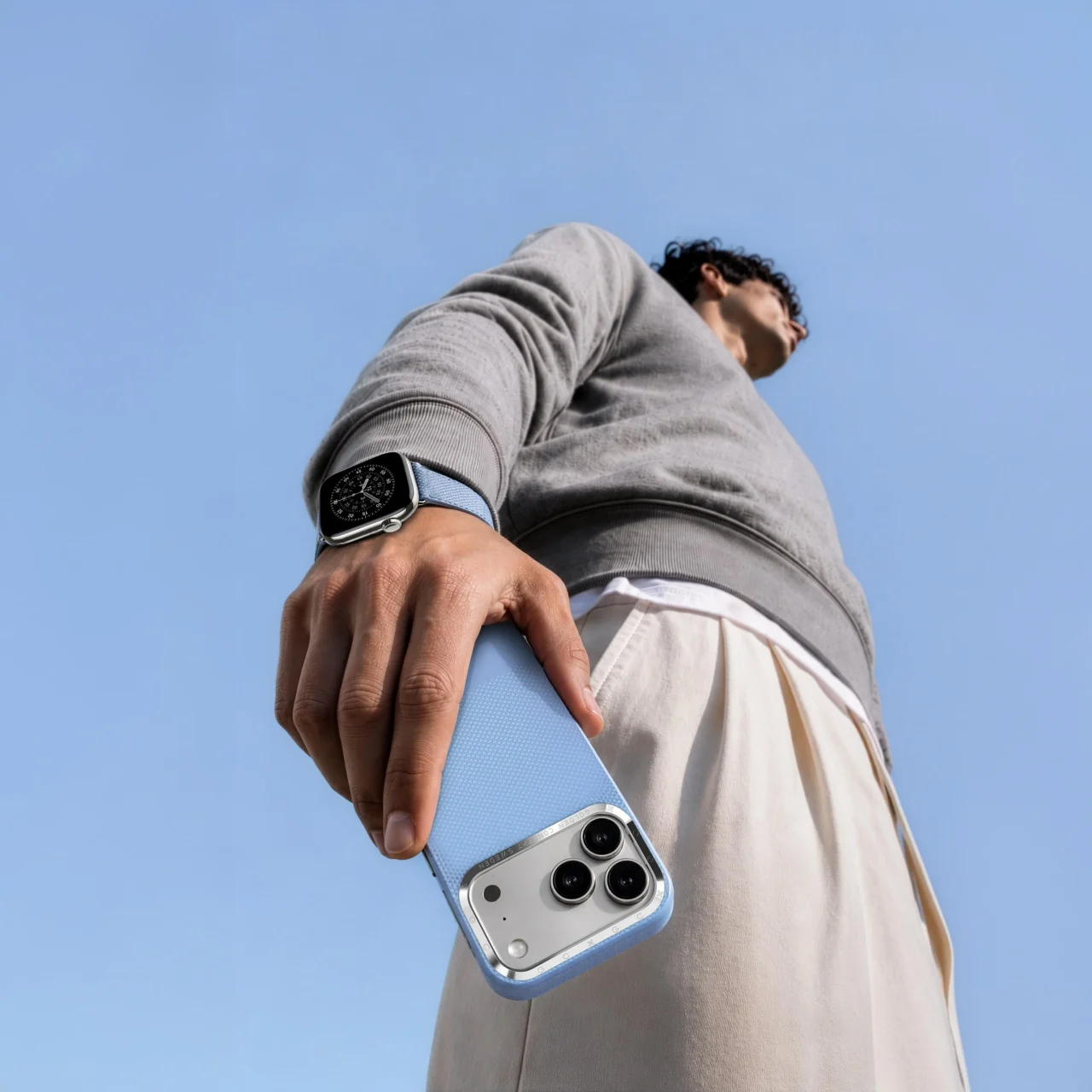 GC ESSENTIALSのiPhoneケースとApple Watchストラップを身につけた人物
