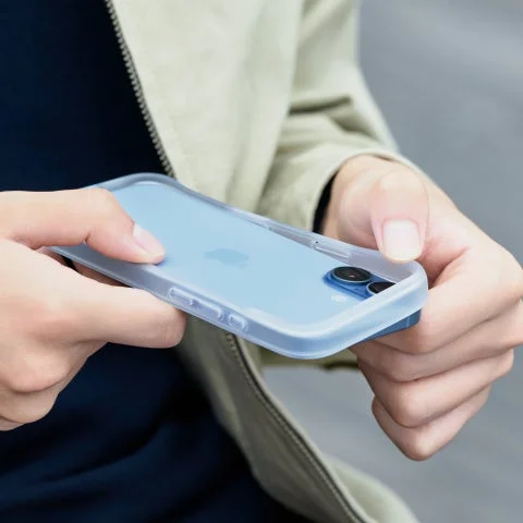 両手でiPhoneに半透明のバンパーケースを装着する様子