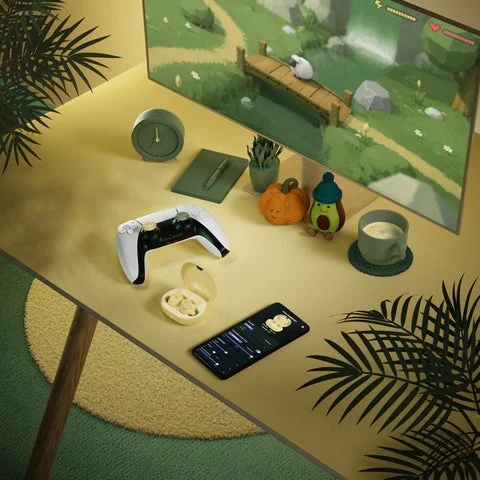 デスク環境に置かれたArctis GameBudsとゲーム周辺機器