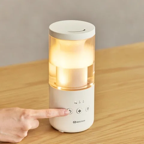 指で加湿器の操作ボタンを押している様子