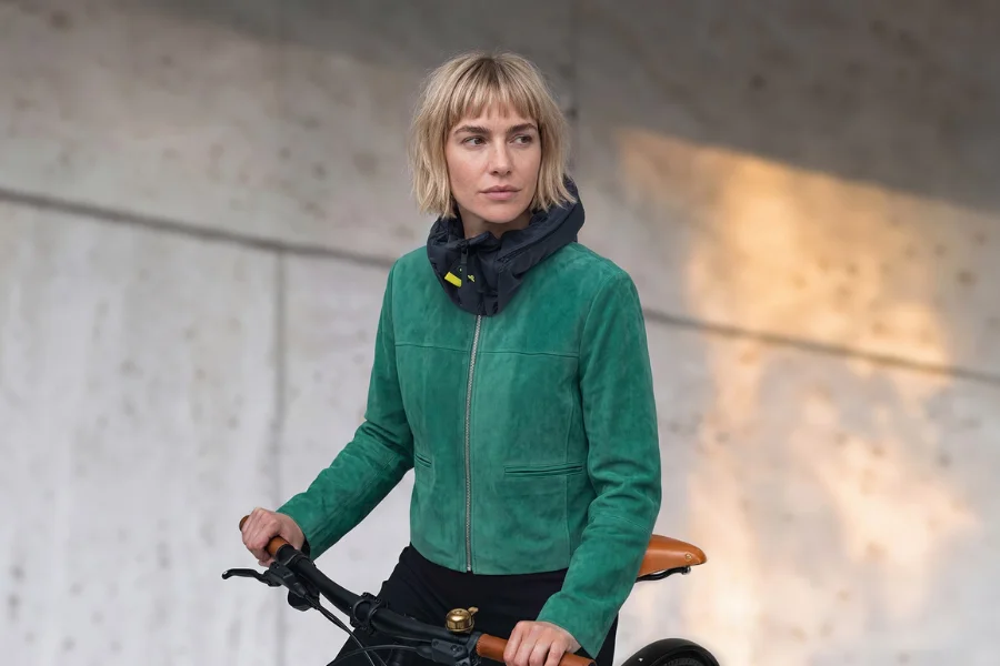 Hövding 4を首に装着した女性が自転車に乗っている着用イメージ