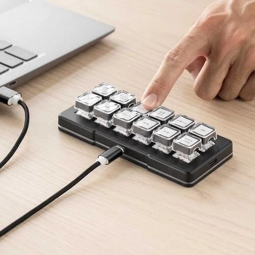 プログラマブルキーボード 400-SKB085を有線接続し指で操作する様子