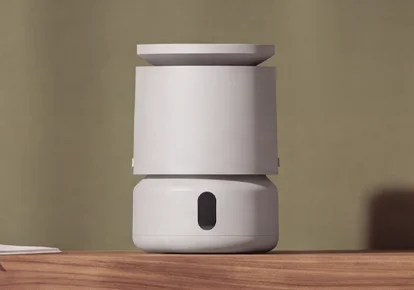 DreamWell™ Mini Humidifier H21 Stone Grey。木の棚に置かれた灰色の円筒形加湿器