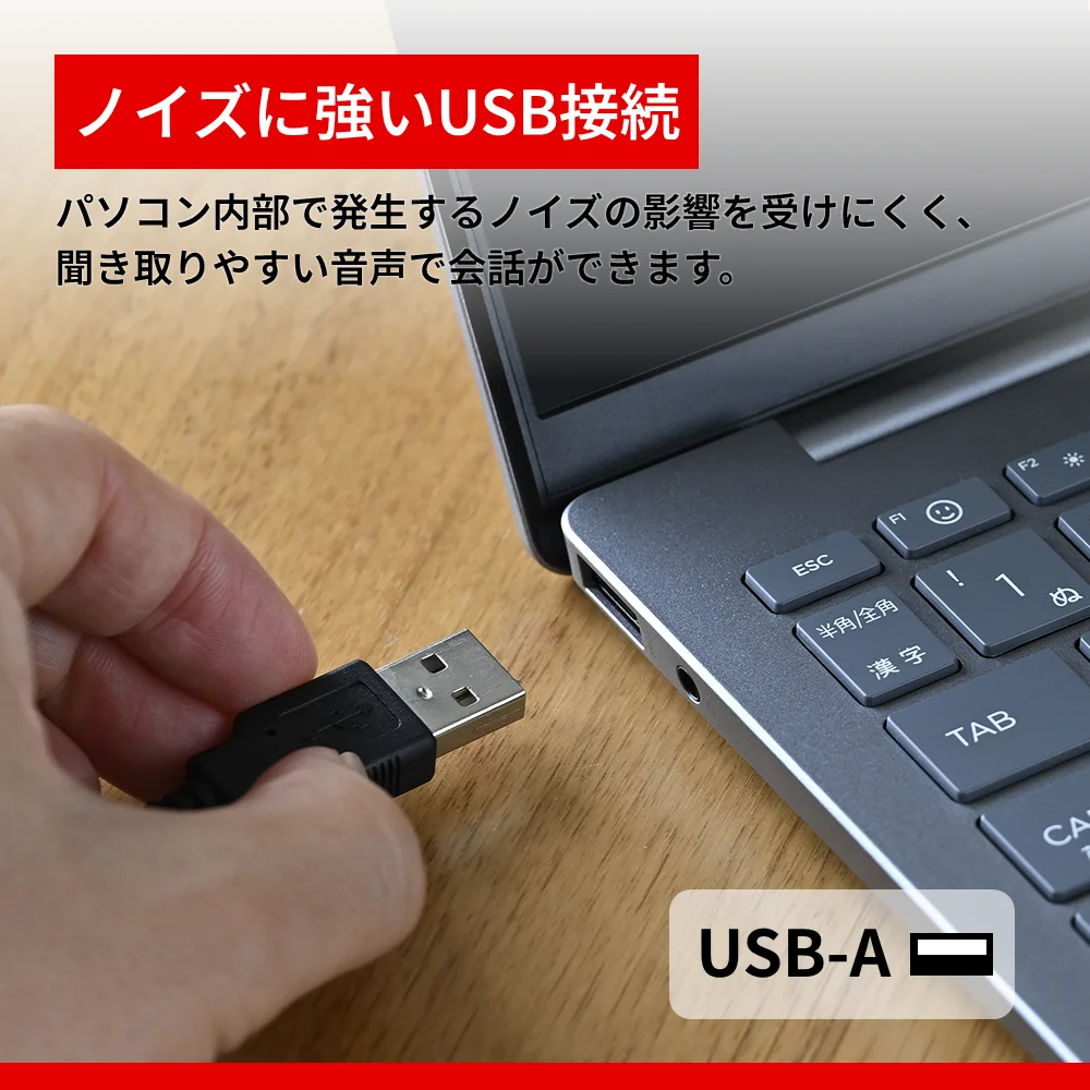ノートパソコンのUSB-A端子に差し込むUSBプラグを持つ手
