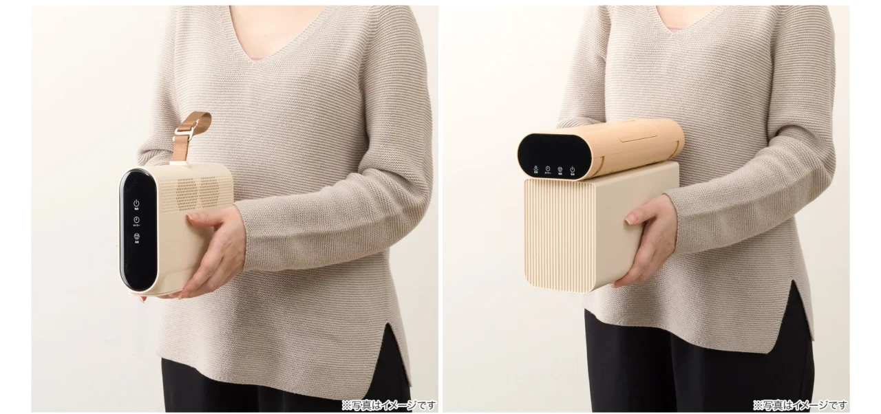 折りたたんでコンパクトに収納できる衣類乾燥機を両手で持つ様子