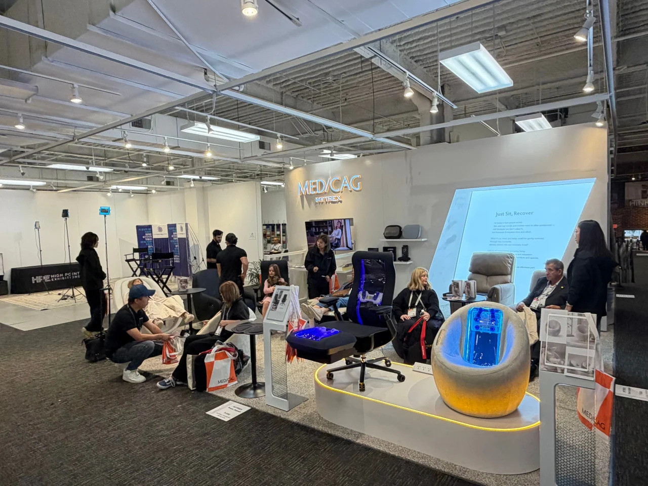 MEDICAGシリーズの展示ブースで来場者が製品を体験する様子