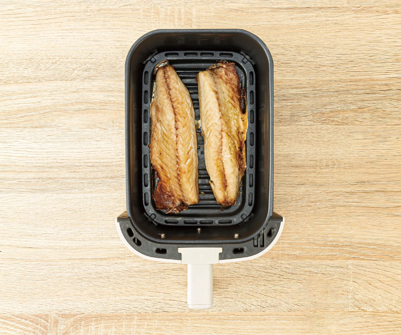 ノンオイルフライヤー4.0Lのトレイで焼き上がった魚の切り身2枚